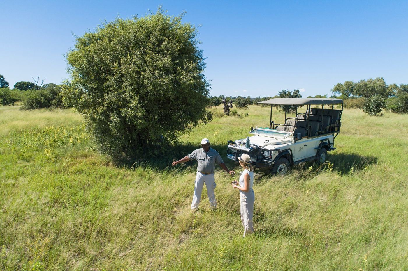 A guide and guest at a drinks stop on a game drive from Khwai Guest House