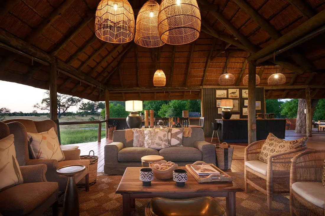 Woven pendant lamps hang over sofas and armchairs in the thatched Little Sable lounge