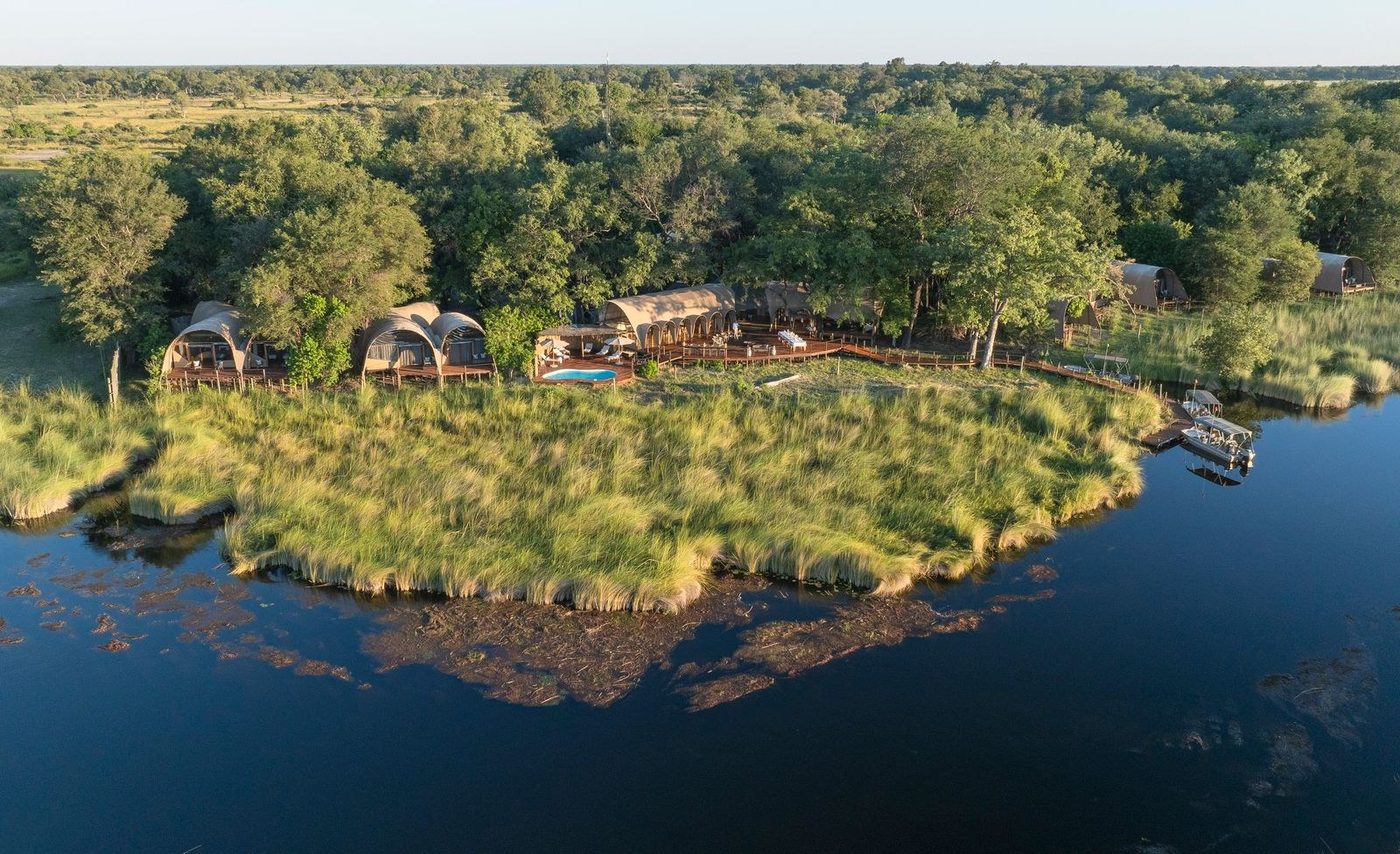 Okuti from the air, its curved chalets and pool on the Maunachira channel in Moremi