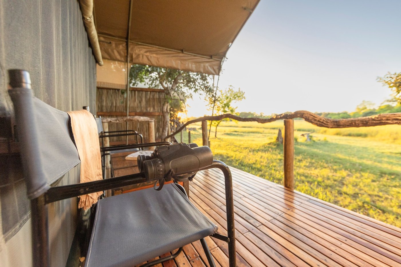 Binoculars ready on the private deck overlooking the floodplain at Sango Safari Camp