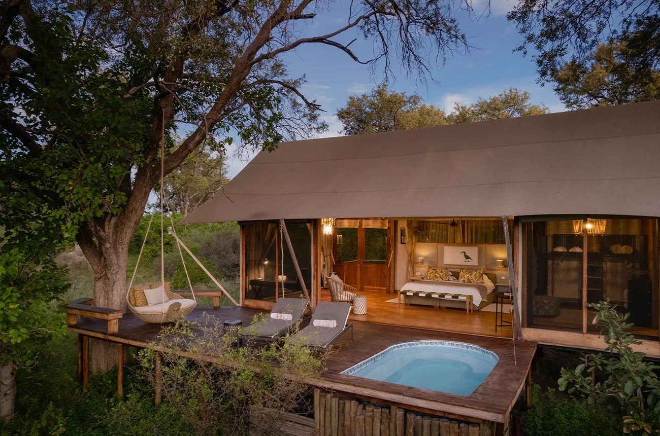 A Tuludi suite with its private plunge pool, loungers and hanging chair on the deck
