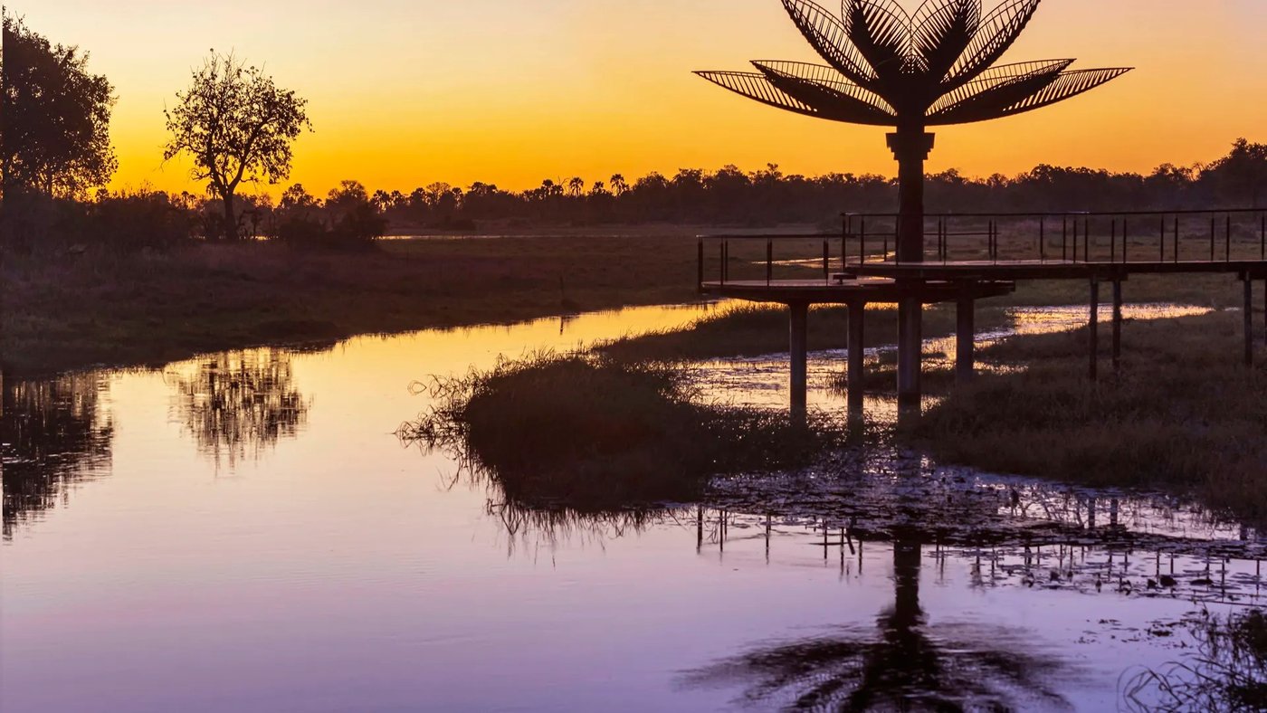 The sculptural lotus deck over the channel at sunset at Xigera Safari Lodge